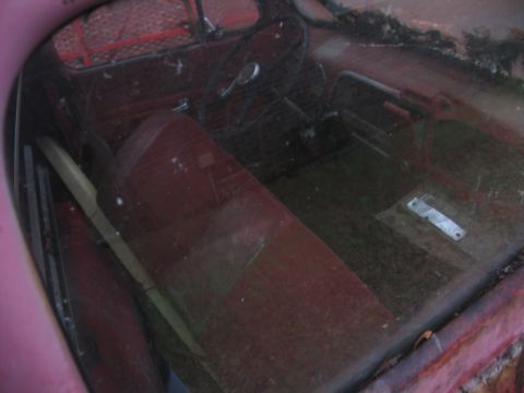 1952 Ford Pickup - Interior view of a 1952 Ford Pickup, its original red upholstery and steering column.