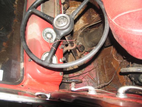 1952 Ford Pickup - Close-up view of the driver's side interior, highlighting the steering wheel and dashboard instruments.