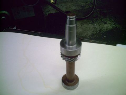 1969 Ford Fairlane - A close-up view of a metal component, possibly a shaft with a gear, is presented against a plain background.