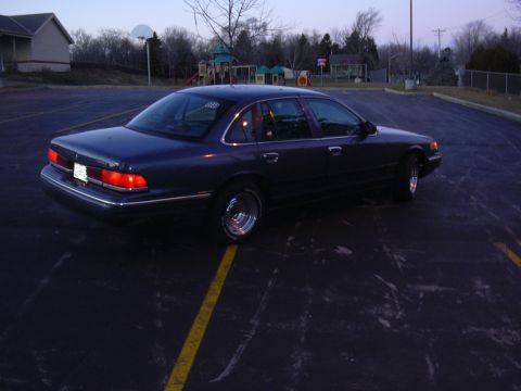 1996 Ford Crown Victoria - A dark blue 1995 Ford Crown Victoria is parked in a lot at dusk.