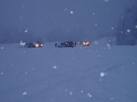 2000 Ford E350 - Multiple vehicles are visible in a snowy landscape, possibly during a trip or event.