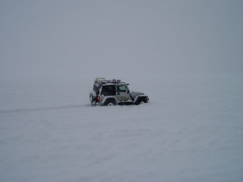 2000 Ford E350 - Jeep Wrangler deep in snow, showing its off-road capability.