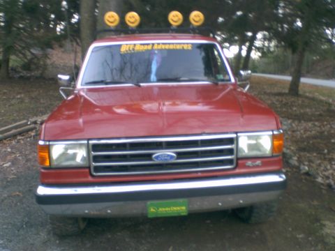1989 Ford Bronco - This red Ford pickup truck has a grille that indicates it is from the late 1980s.