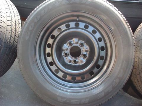 1997 Ford Crown Victoria - A close-up view of a steel wheel and tire, with visible text from the tire manufacturer.
