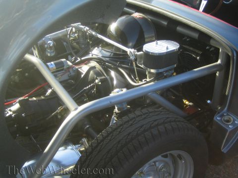 1985 Ford Mustang - Close-up view of a modified engine bay, a roll cage and custom air intake.