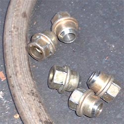 1997 Ford Crown Victoria - Close-up of lug nuts and a hose, with a Supermotors.net watermark.