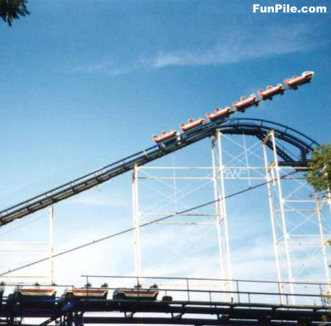 1997 Ford Crown Victoria - A roller coaster train ascends a lift hill, with another train waiting on the station track below.