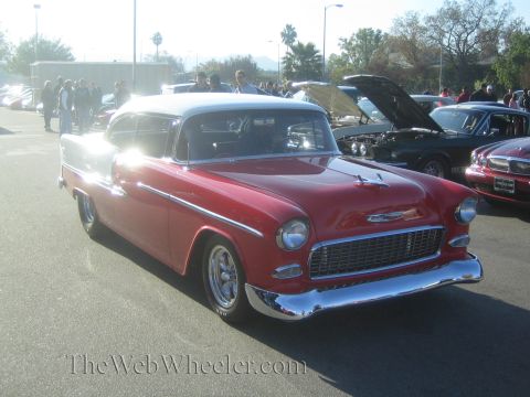 1985 Ford Mustang - Red and white 1955 Chevrolet Bel Air at a car show. The album claims it's a 1985 Ford Mustang, but it is not.