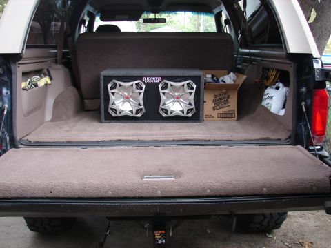 1996 Ford Bronco - The rear cargo area of a 1996 Ford Bronco shows a Kicker subwoofer box and a box of Castrol fluids.