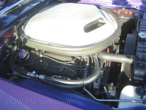 1985 Ford Mustang - Close-up of a car's engine bay, focusing on the air intake system and engine components.