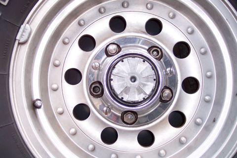 1996 Ford Bronco - Detail of a silver wheel with a manual locking hub, likely from a truck or SUV.