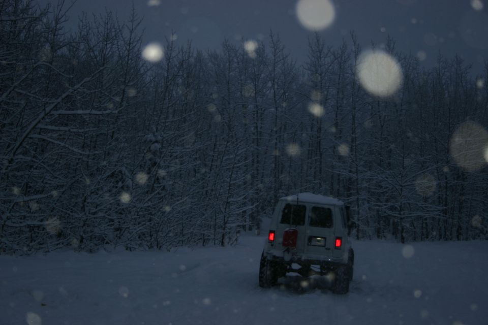 2003 Jeep TJ parked in snow with trees in background