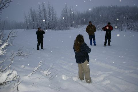 2003 Jeep TJ - A group of people are gathered in a snowy outdoor area during a snowfall.