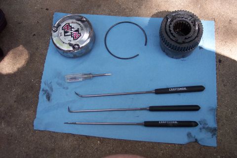 1996 Ford Bronco - Manual hub components and assorted Craftsman tools are arranged on blue shop towels, ready for service.
