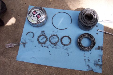 1996 Ford Bronco - A disassembled automatic locking hub, likely for a 4x4 vehicle, is laid out on a blue paper towel.