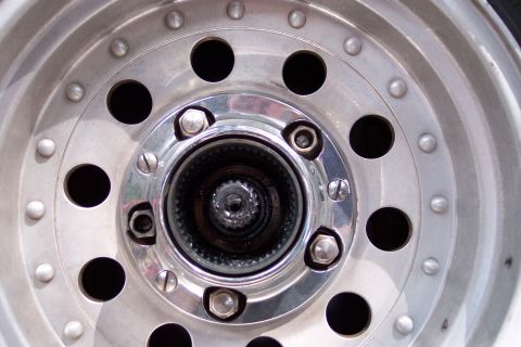 1996 Ford Bronco - A detailed view of a manual locking hub assembly on a vehicle's wheel.