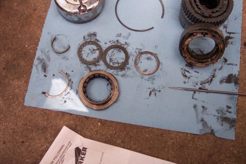 1996 Ford Bronco - Various components of a manual locking hub are spread out on a blue towel, suggesting a repair or maintenance task.