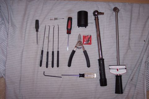 1996 Ford Bronco - Various tools, including two torque wrenches, are arranged on a striped surface, suggesting preparation for a mechanical task.