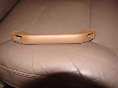 1996 Ford Bronco - A tan interior grab handle is shown resting on a brown leather seat, with a Supermotors watermark at the bottom.