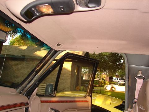 1996 Ford Bronco - Interior view of a 1996 Ford Bronco, looking out the open door at other vehicles in the driveway.