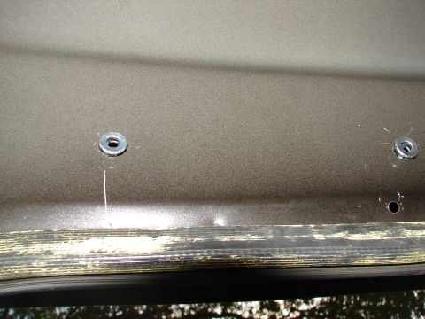 1996 Ford Bronco - Mounting points for an interior grab handle, showing two bolt holes with washers.