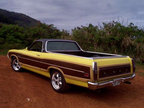 1970 Ford Ranchero - This 1970 Ford Ranchero features a distinctive yellow and wood-paneled exterior with chrome wheels.