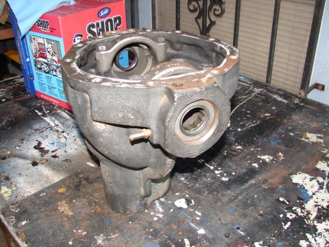 1996 Ford Bronco - A differential housing sits on a cluttered workbench next to a Scott Shop box.