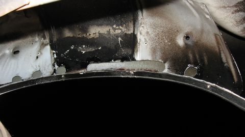 1994 Ford Bronco - This image shows the interior of a vehicle's wheel well, highlighting areas of repair and potential rust.