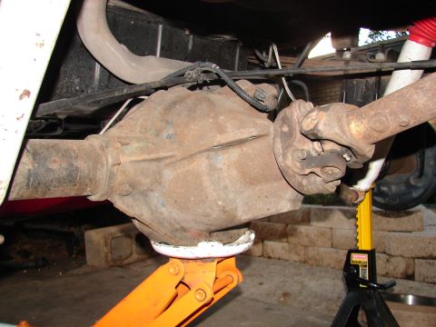 1996 Ford Bronco - The rear differential and driveshaft of a 1996 Ford Bronco are visible, supported by jacks.