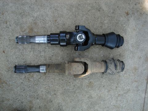 1996 Ford Bronco - Comparison of a new axle shaft with an older, worn one, likely for an upgrade or replacement.