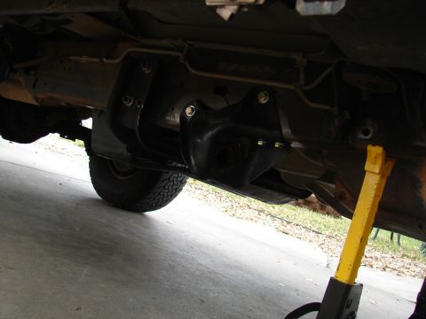 1996 Ford Bronco - The photo shows the undercarriage of a vehicle, focusing on the suspension and a lift kit installation.