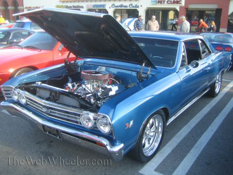 1985 Ford Mustang - A blue classic car is parked with its hood open, revealing the engine compartment.