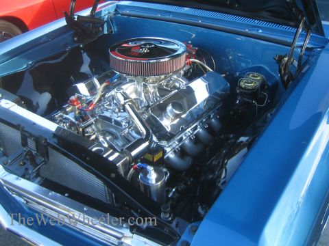 1985 Ford Mustang - Close-up view of a V8 engine in a blue car's engine bay.
