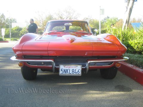 1985 Ford Mustang - This red 1963 Chevrolet Corvette Sting Ray is shown from the rear at a car show.