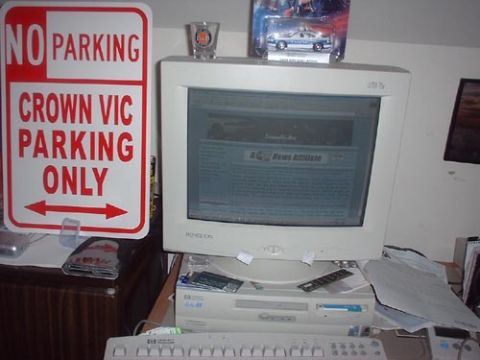 1997 Ford Crown Victoria - A sign indicates that only Crown Victoria vehicles are permitted to park in this area.