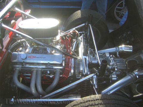 1985 Ford Mustang - A highly polished Chevrolet engine is on display at a car show.