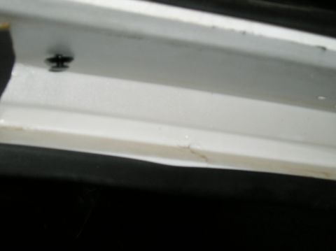 1993 Ford Bronco - Close-up of a white trim piece, likely interior, with a visible screw and the Supermotors.net website address at the bottom.