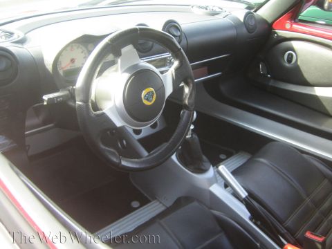 1985 Ford Mustang - Interior view of a Lotus Elise, showing the steering wheel, dashboard, and seats.