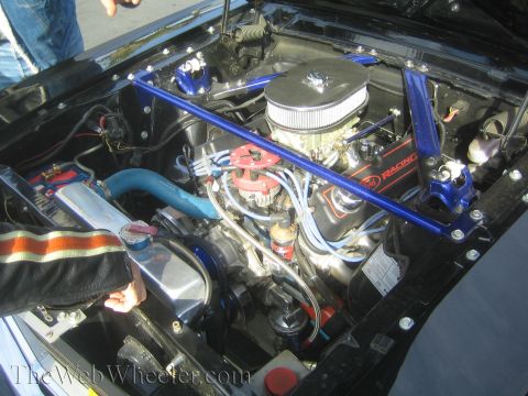 1985 Ford Mustang - The engine bay features Ford Racing valve covers and a blue strut bar, suggesting performance modifications.