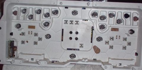 1997 Ford Crown Victoria - The rear of a vehicle's instrument cluster shows the complex wiring and mounting points for its components.
