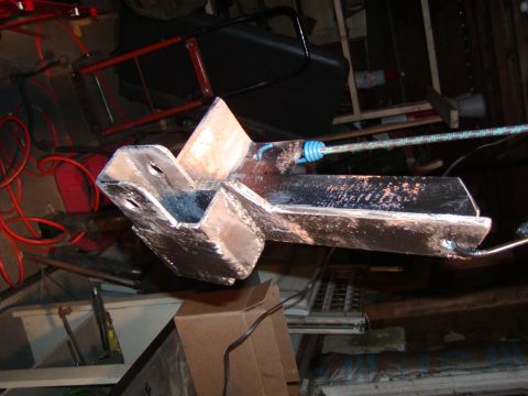 1991 Ford Bronco - A metal bracket is attached to a rope in a workshop environment.