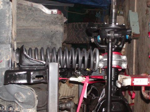 1991 Ford Bronco - Front suspension components, including a coil spring and steering linkage, are visible in this close-up.