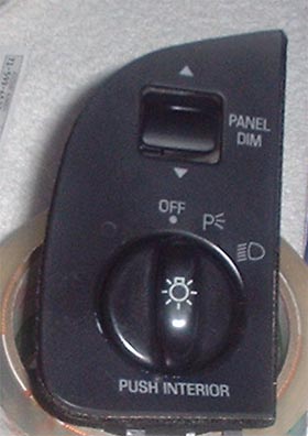 1997 Ford Crown Victoria - Headlight switch panel with various controls and labels, including 'PANEL DIM' and 'PUSH INTERIOR'.