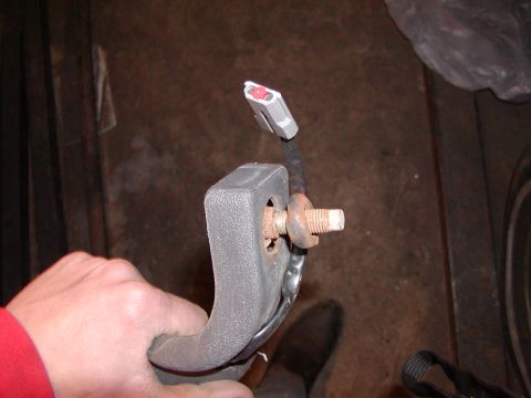 1991 Ford Bronco - A close-up view of a seatbelt buckle assembly, showing its internal components and connection.