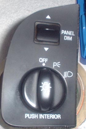1997 Ford Crown Victoria - A close-up of a vehicle's interior headlight control panel, showing various settings and labels.