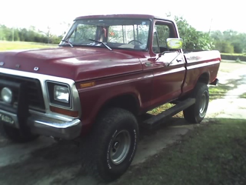 1979 Ford F-150 - A red 1979 Ford F-150 pickup truck is shown from a three-quarter front angle.