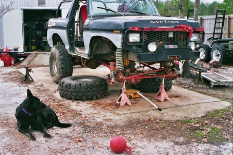 1978 Ford Bronco - This modified SUV is undergoing repairs with its front end lifted and parts removed.