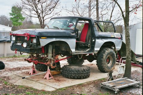 1978 Ford Bronco - This heavily modified 1978 Ford Bronco is undergoing repairs, with its front end lifted and parts removed.