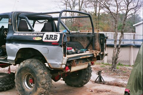 1978 Ford Bronco - Modified 1978 Ford Bronco rear view, showing roll cage and off-road tires.
