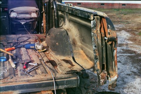1978 Ford Bronco - Tools and rust in the bed of a truck, possibly undergoing repair.